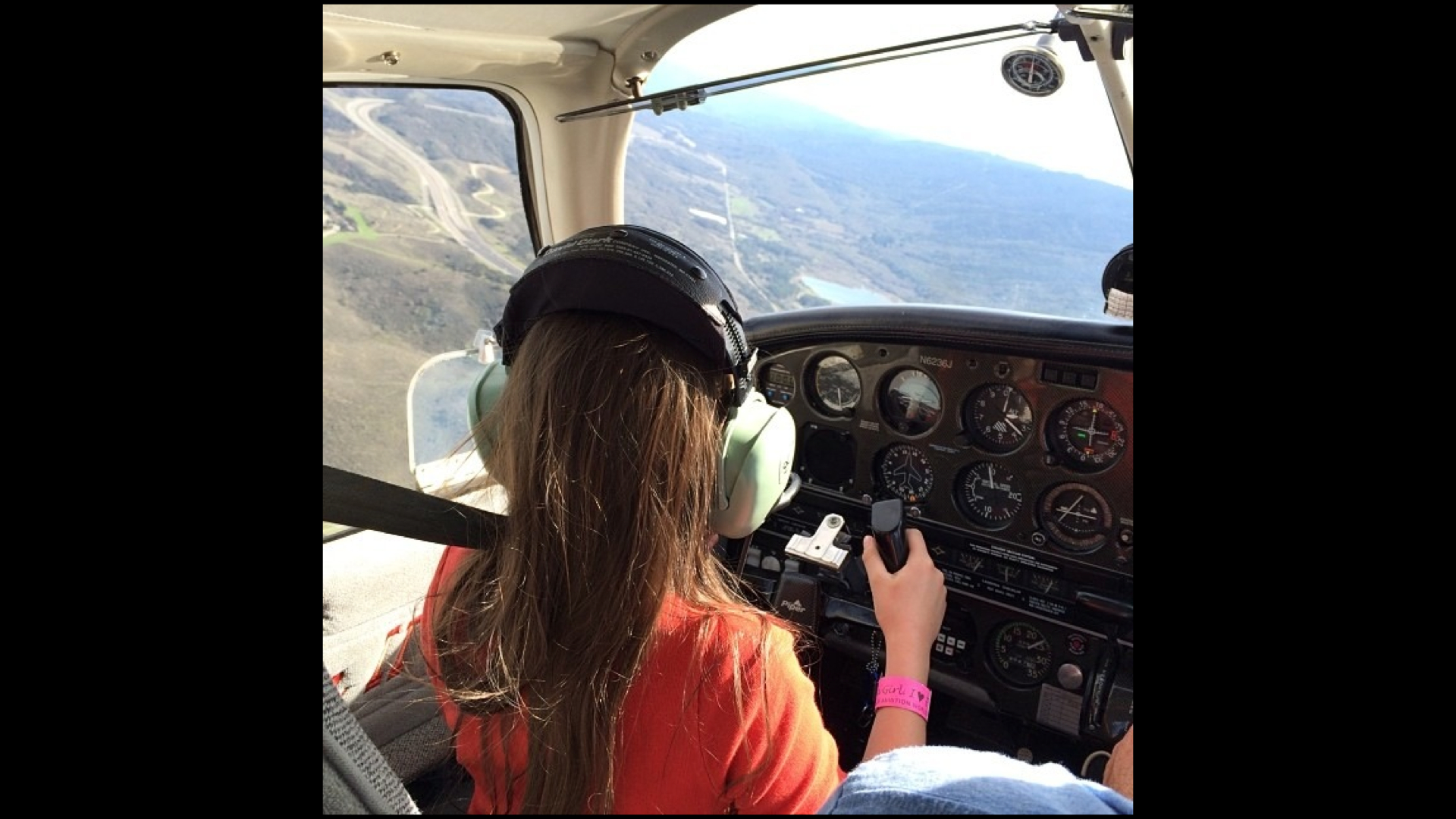 A slide showing a picture of a 10-year-old girl, flying a small plane.